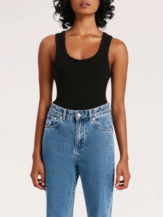 Image of a model wearing Tops. Productname: Nude Lucy Organic Rib Singlet in Black colour by brand - Nude Lucy