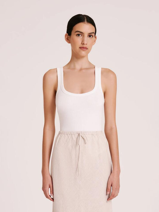 Image of a model wearing Tops. Productname: Nude Lucy Organic Rib Singlet in White colour by brand - Nude Lucy
