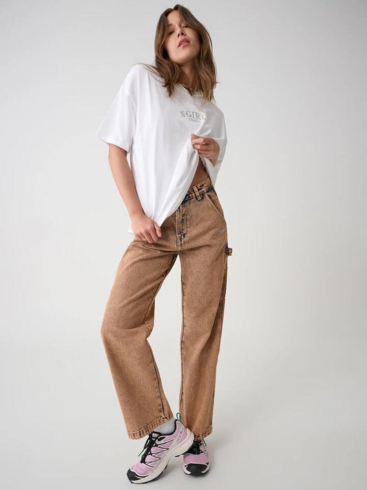 Image of a model wearing Pants. Productname: Xgirl Mills Carpenter Pant in Blush colour by brand - Xgirl