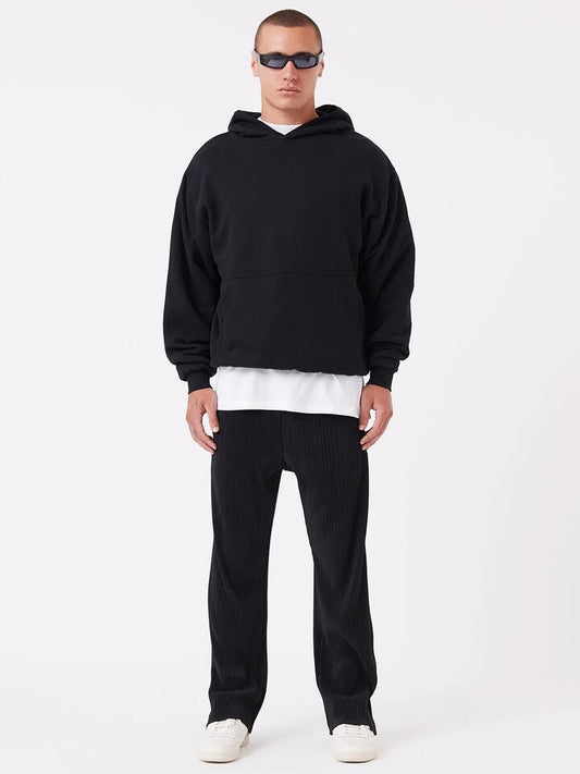 Image of a model wearing Pants. Productname: Zanerobe Pleated Pant in Black colour by brand - Zanerobe