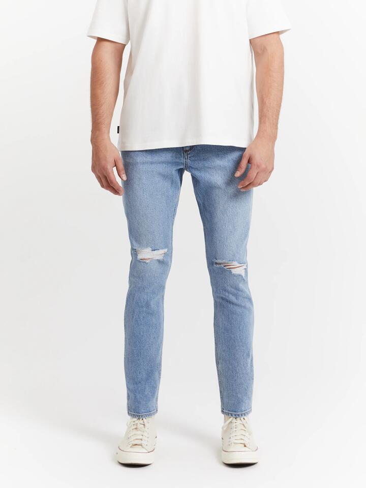 Image of a model wearing Denim. Productname: Wrangler Sid Smash Jeans in Denim colour by brand - Wrangler