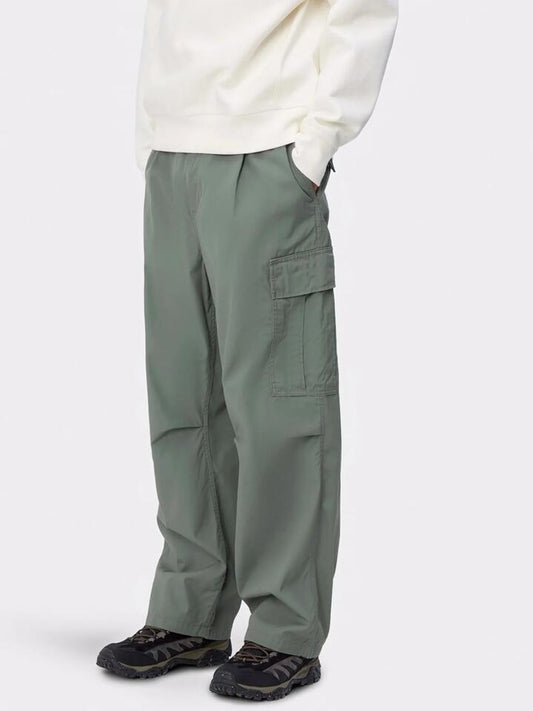 Image of a model wearing Pants. Productname: Carhartt Wip Cole Cargo Pants in Park colour by brand - Carhartt Wip