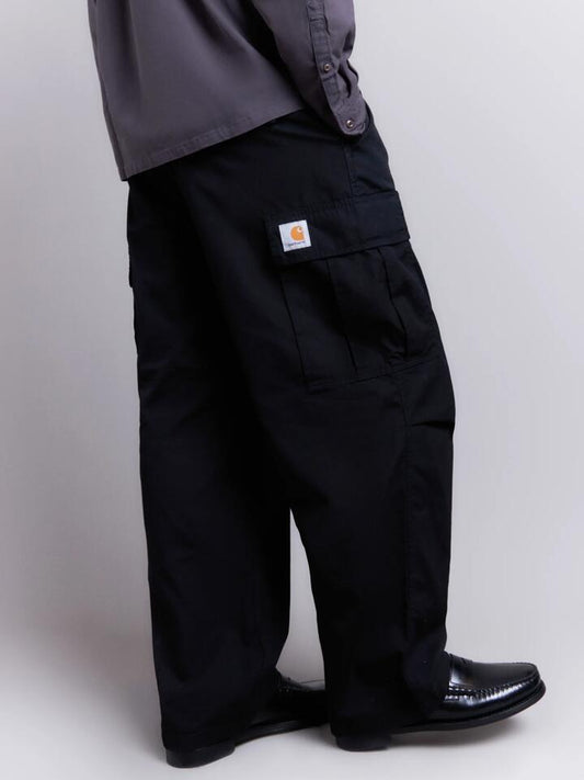Image of a model wearing Pants. Productname: Carhartt Wip Cole Cargo Pants in Black Rinsed colour by brand - Carhartt Wip