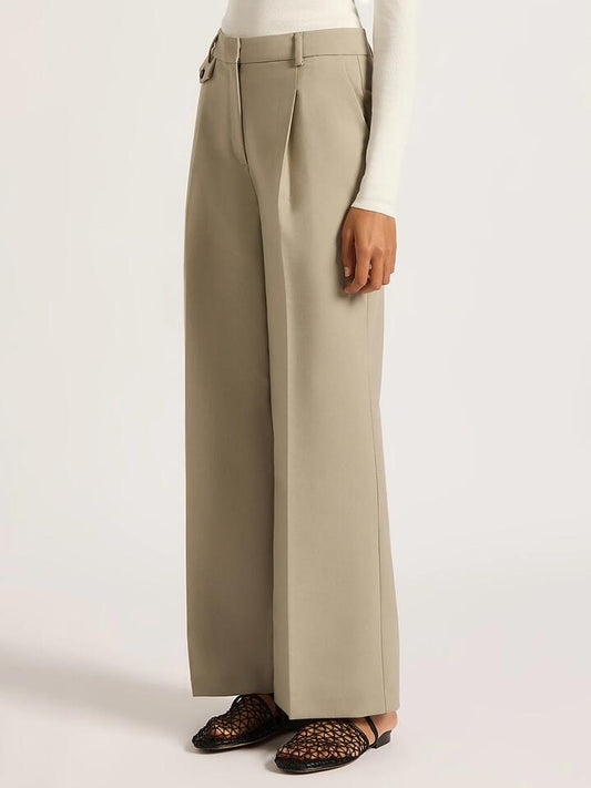 Image of a model wearing Pants. Productname: Nude Lucy Theo Tailored Pants in Sage colour by brand - Nude Lucy