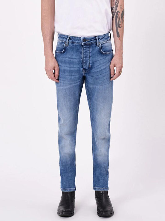 Image of a model wearing Denim. Productname: Neuw Ray Tapered Tempest Jeans in Mid Indigo colour by brand - Neuw