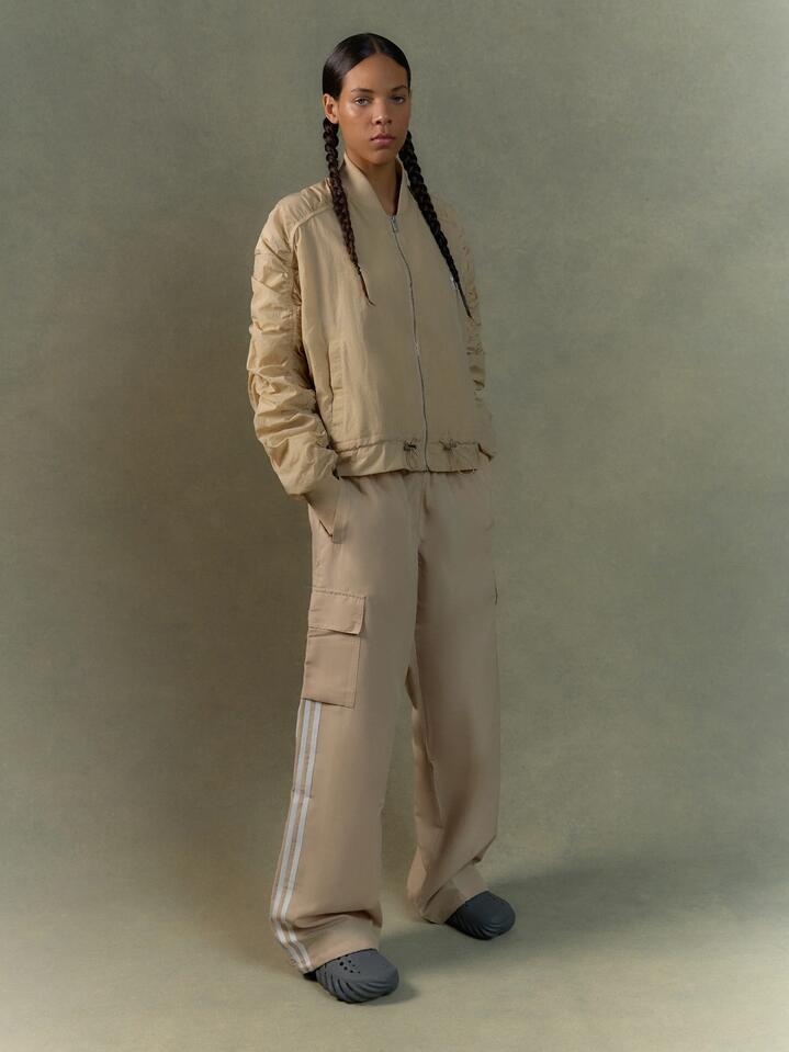 Image of a model wearing Pants. Productname: Adidas 3 Stripe Cargo Pants in Magic Beige colour by brand - Adidas