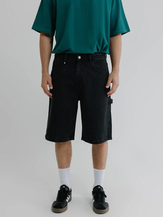 Image of a model wearing Denim. Productname: Thrills Big Slacker Embro Denim Shorts in Aged Black colour by brand - Thrills