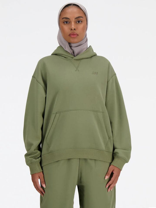 Image of a model wearing Outerwear. Productname: New Balance Athletics French Terry Hoodie in Dark Olivine colour by brand - New Balance