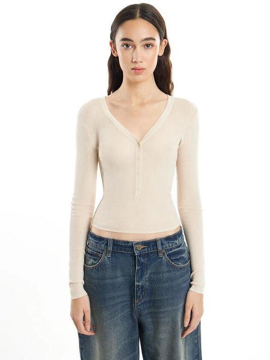 Image of a model wearing Tops. Productname: First Mse Mse Knit Button Top in Shell colour by brand - First Mse