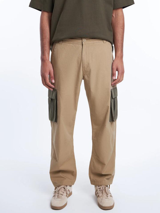 Image of a model wearing Pants. Productname: Article One Wyatt Cargo Pants in Tan colour by brand - Article One