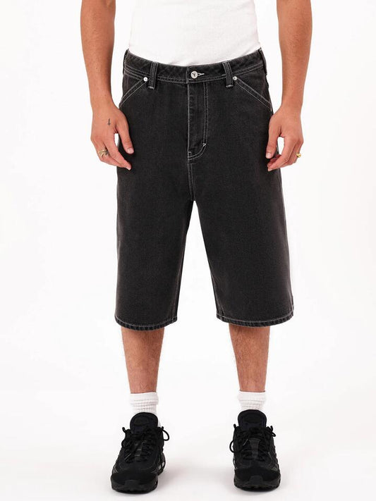 Image of a model wearing Shorts. Productname: Abrand A6 Big Baggy Short Paxton Jorts in Washed Black colour by brand - Abrand