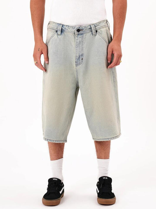 Image of a model wearing Shorts. Productname: Abrand A6 Big Baggy Short Milo Jorts in Bleached Vintage Indigo colour by brand - Abrand