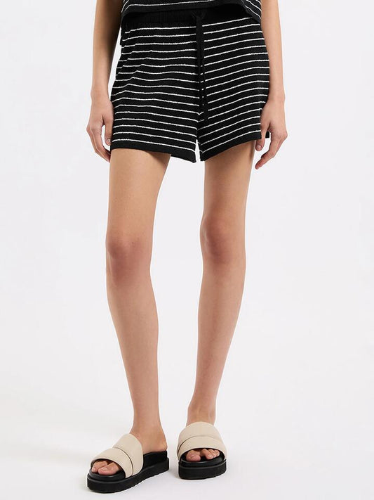 Image of a model wearing Shorts. Productname: Nude Lucy Zosia Stripe Knit Shorts in Black Stripe colour by brand - Nude Lucy