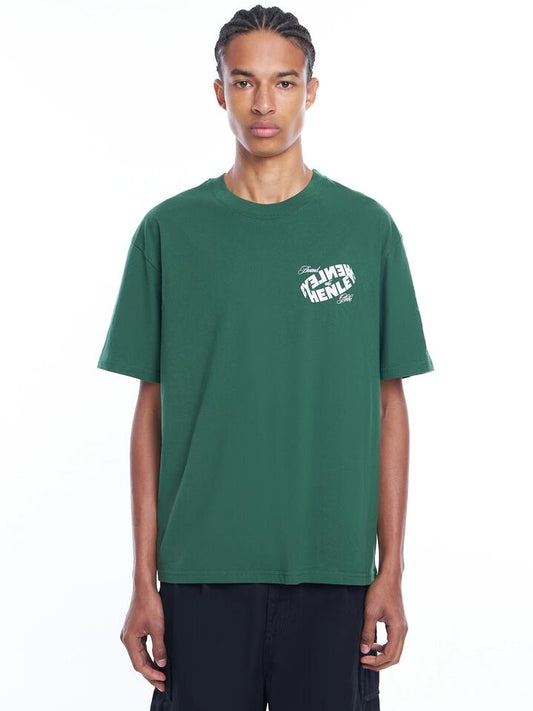 Image of a model wearing Tops. Productname: Henleys World Tee in Sycamore Green colour by brand - Henleys