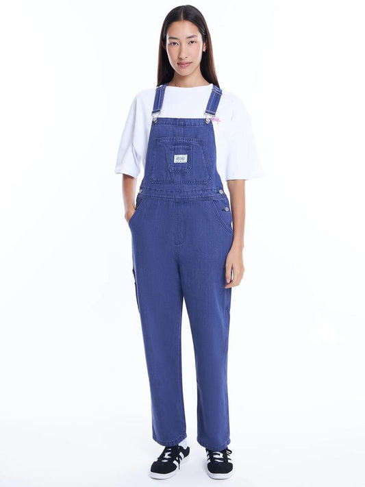 Image of a model wearing Pants. Productname: Stussy Nevada Denim Overall in Purple colour by brand - Stussy