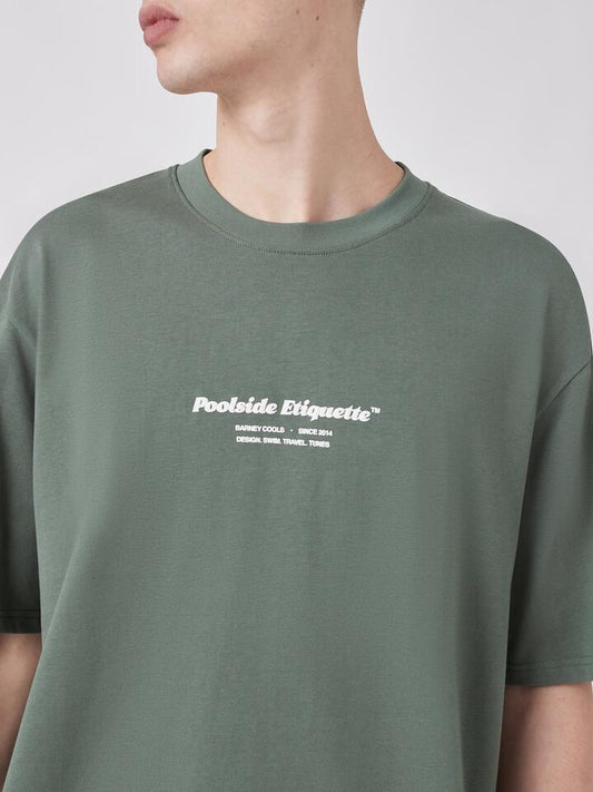 Image of a model wearing Tops. Productname: Barney Cools Etiquette Tee in Pine colour by brand - Barney Cools