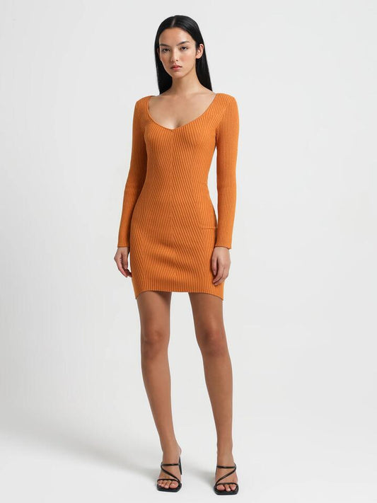 Image of a model wearing Dress. Productname: Lulu & Rose Elsa Knitted Dress in Marigold colour by brand - Lulu & Rose