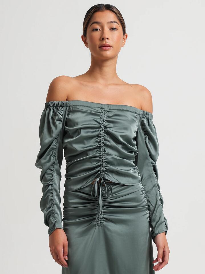 Image of a model wearing Tops. Productname: Lulu & Rose Tamara Ruched Top in Jewel colour by brand - Lulu & Rose