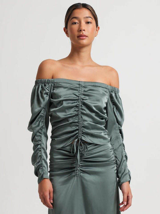 Image of a model wearing Tops. Productname: Lulu & Rose Tamara Ruched Top in Jewel colour by brand - Lulu & Rose
