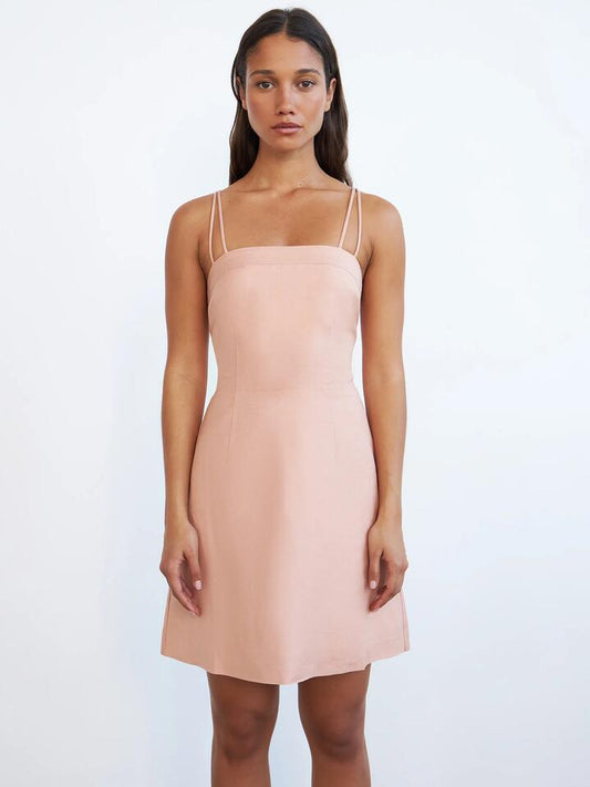 Image of a model wearing Dress. Productname: Lulu & Rose Charlotte Mini Dress in Peach colour by brand - Lulu & Rose
