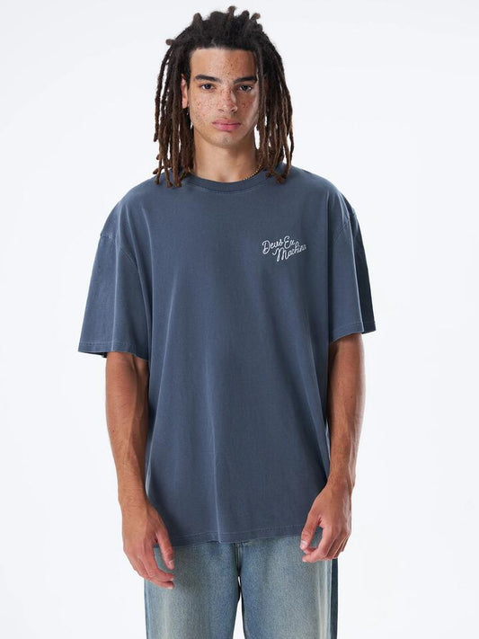 Image of a model wearing Tops. Productname: Deus GD Roadhouse Tee in Caviar colour by brand - Deus