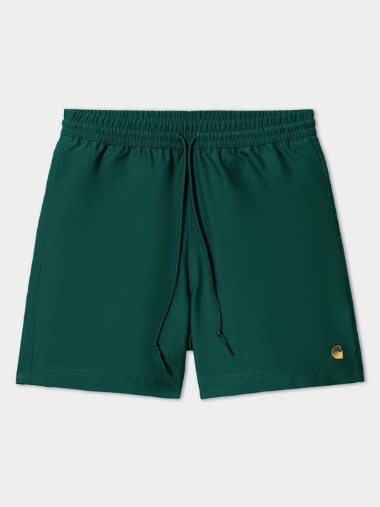 Image of a model wearing Shorts. Productname: Carhartt Wip Chase Swim Trunks in Chervil/Gold colour by brand - Carhartt Wip