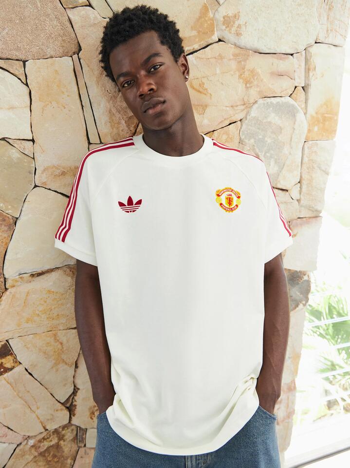 Image of a model wearing Tops. Productname: Adidas Manchester United T-Shirt in Off White colour by brand - Adidas