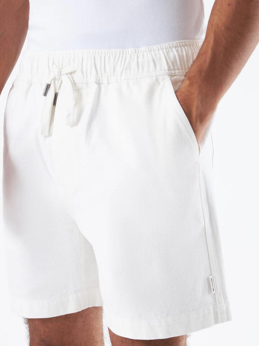 Image of a model wearing Shorts. Productname: Article One Benzo Short in Off White colour by brand - Article One
