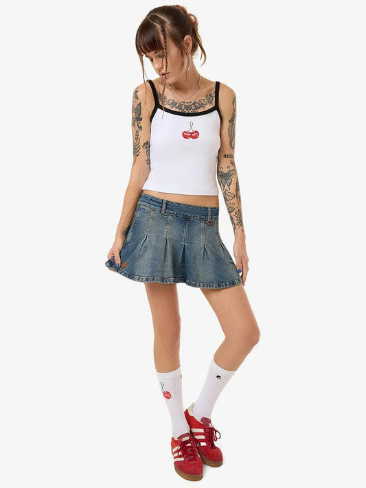 Image of a model wearing Denim. Productname: Worship Fast Lane Pleated Denim Mini Skirt in Dirty Mid Blue colour by brand - Worship