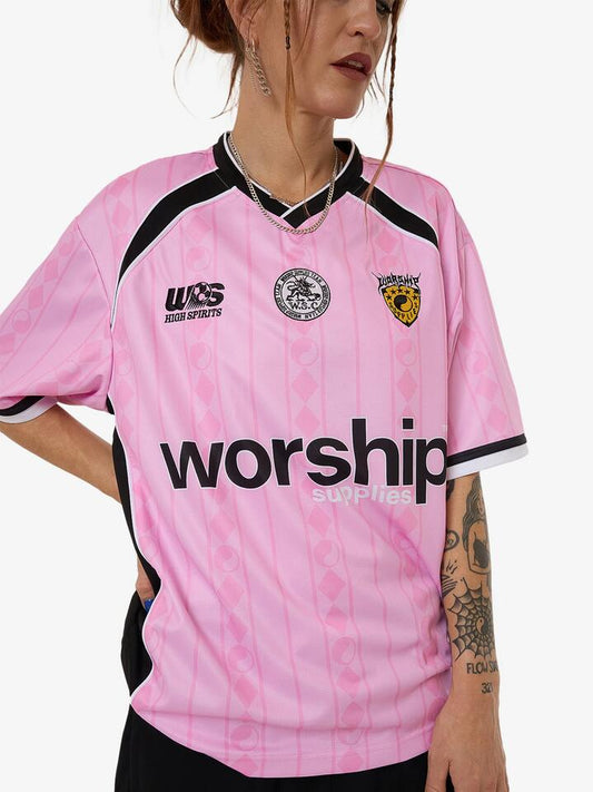 Image of a model wearing Tops. Productname: Worship Player V-Neck Football Jersey in Bubblegum Pink colour by brand - Worship