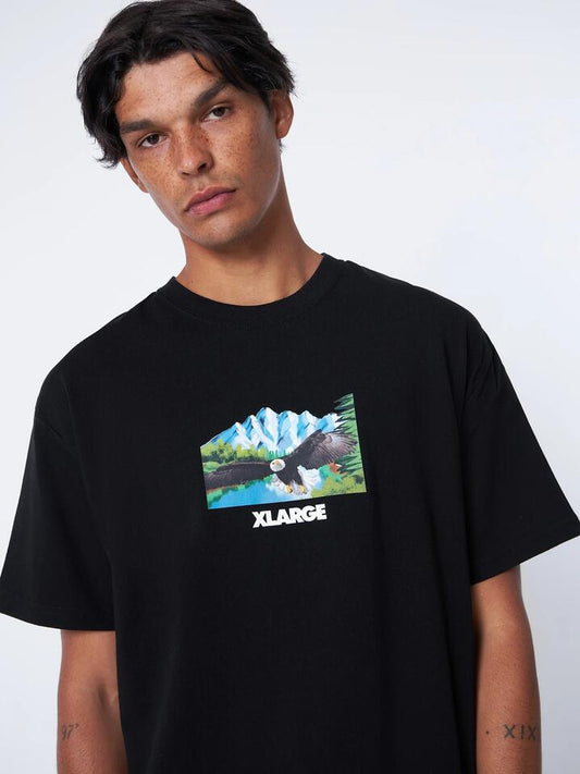 Image of a model wearing Tops. Productname: Xlarge Eagle Tee in Black colour by brand - Xlarge