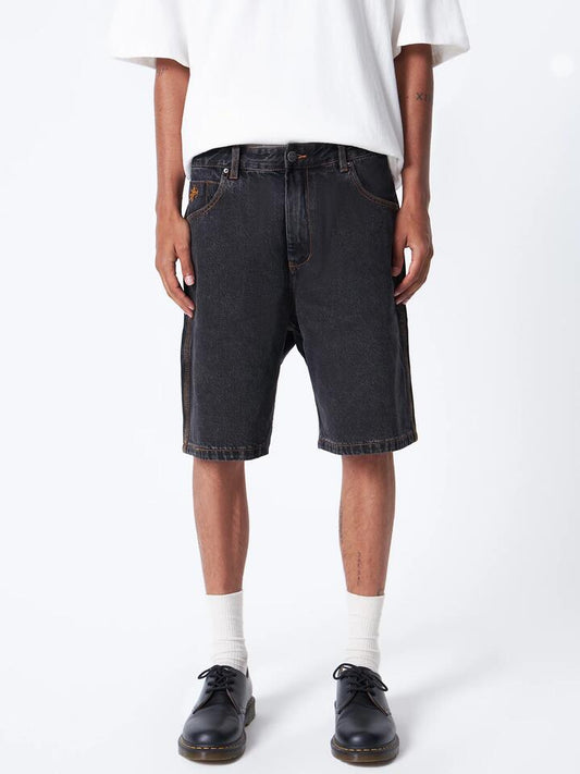 Image of a model wearing Denim. Productname: Worship Big Dawg Jean Short in Black Rinse colour by brand - Worship