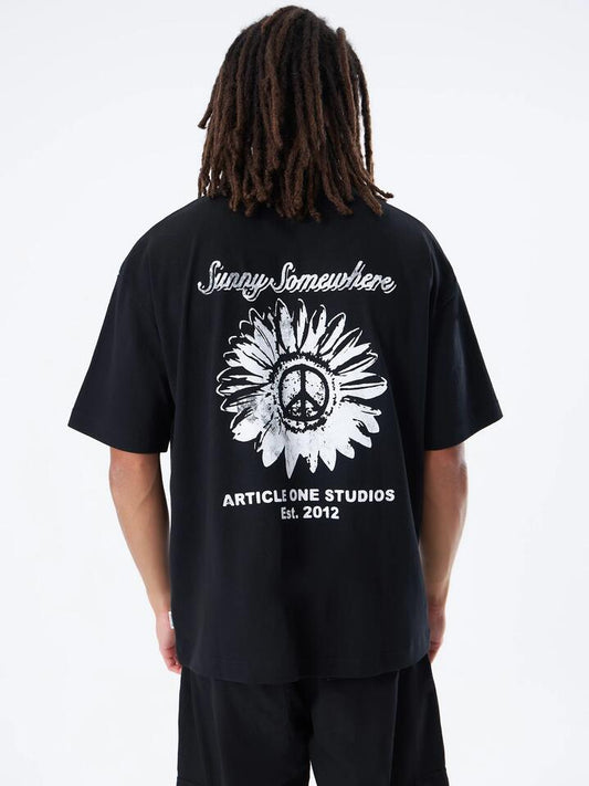 Image of a model wearing Tops. Productname: Article One Sunny Somewhere Boxy Tee in Black colour by brand - Article One