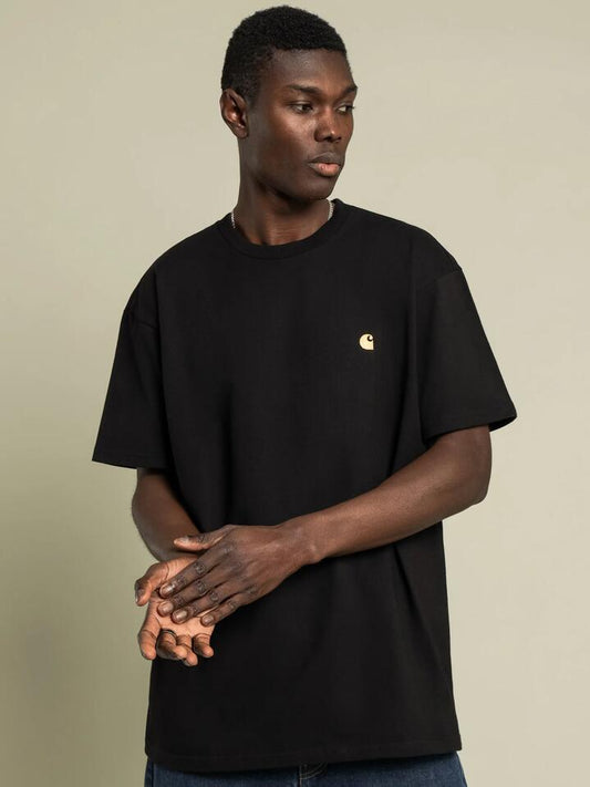 Image of a model wearing Tops. Productname: Carhartt Wip S/S Chase T-Shirt in Black/Gold colour by brand - Carhartt Wip