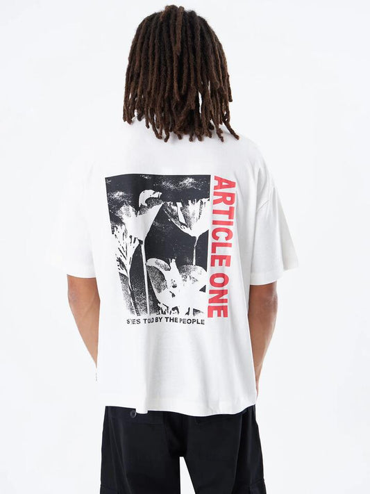 Image of a model wearing Tops. Productname: Article One Stories Boxy Tee in Off White colour by brand - Article One