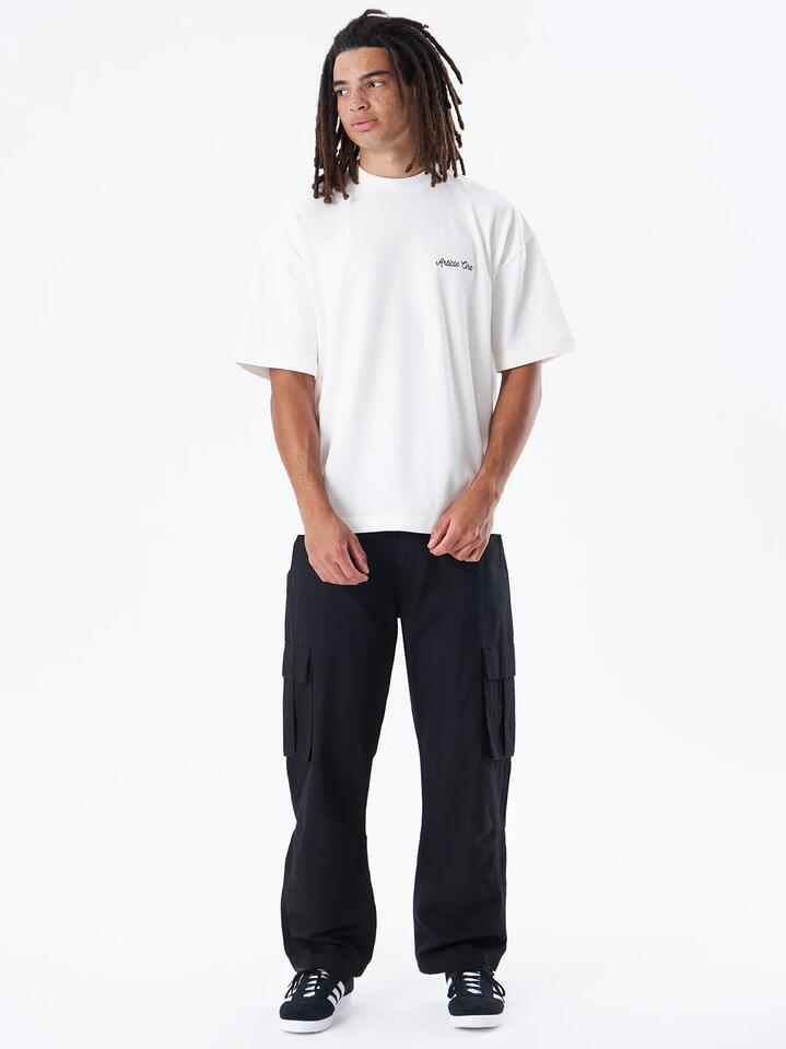 Image of a model wearing Tops. Productname: Article One Chainstitch Logo Tee in Natural colour by brand - Article One