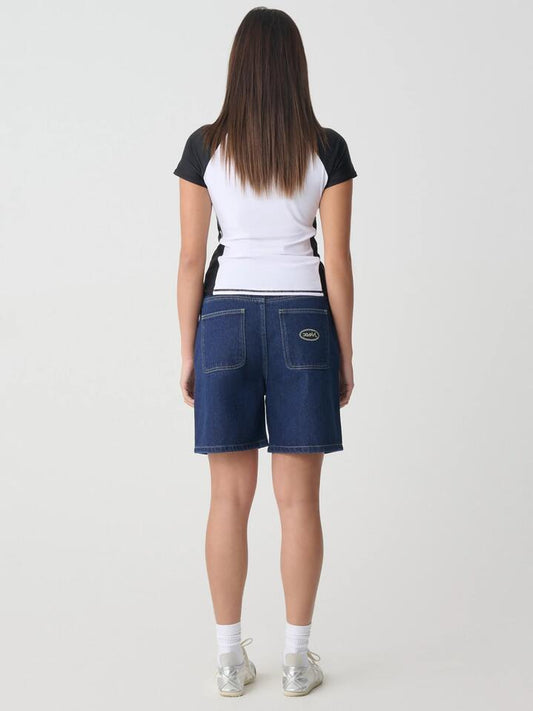 Image of a model wearing Shorts. Productname: Xgirl Gordon Short in Dark Blue colour by brand - Xgirl