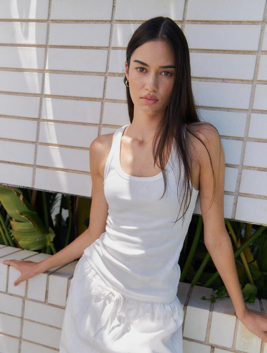 Image of a model wearing Tops. Productname: Lulu & Rose L&R Rib Tank in Off White colour by brand - Lulu & Rose