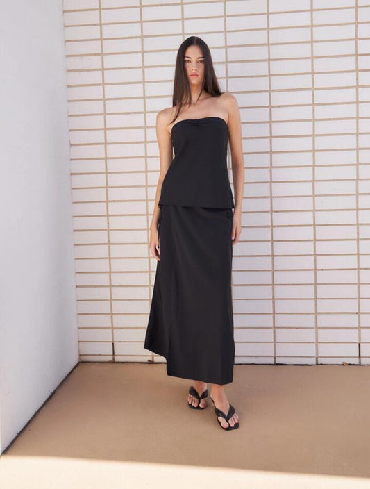 Image of a model wearing Skirts. Productname: Lulu & Rose Meg Wrap Midi Skirt in Black colour by brand - Lulu & Rose