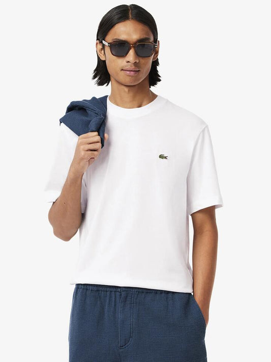 Image of a model wearing Tops. Productname: Lacoste Essential Classic Fit T-Shirt in White colour by brand - Lacoste