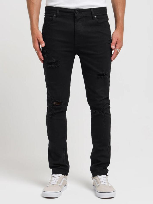 Image of a model wearing Denim. Productname: Article One Arden Rip Skinny Jeans in True Black colour by brand - Article One