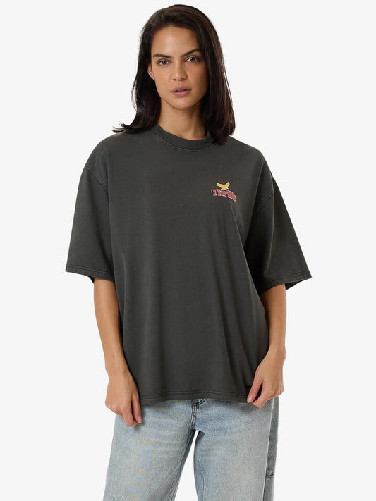Image of a model wearing Tops. Productname: Thrills Never Stop Oversized Tee in Merch Black colour by brand - Thrills