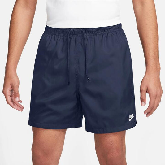 Image of a model wearing Shorts. Productname: Nike Club Woven Flow Shorts in Midnight Navy/White colour by brand - Nike