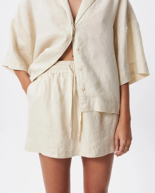Image of a model wearing Skirts. Productname: Lulu & Rose L&R Drawstring Mini Skirt in Natural colour by brand - Lulu & Rose