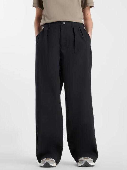 Image of a model wearing Pants. Productname: New Balance Boylston Twill Trouser in Black colour by brand - New Balance