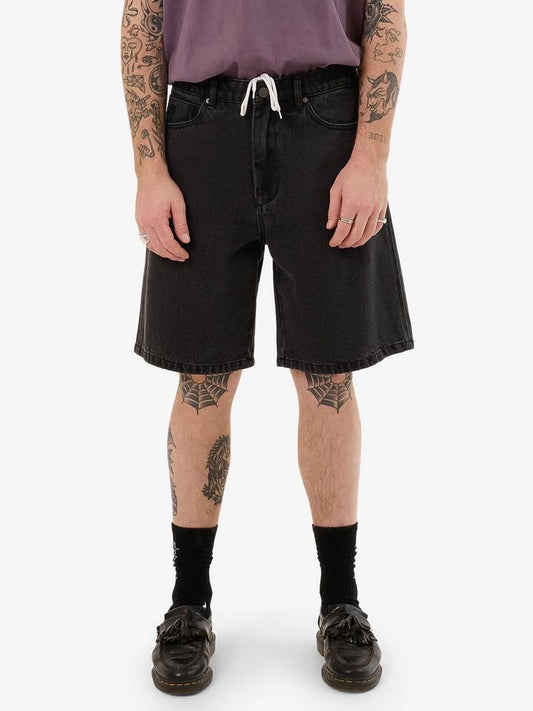 Image of a model wearing Denim. Productname: Worship Nuclear Lounger Jean Short in Used Black colour by brand - Worship