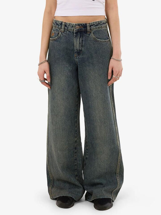Image of a model wearing Denim. Productname: Worship Sweeper Jean in Blue Haze colour by brand - Worship