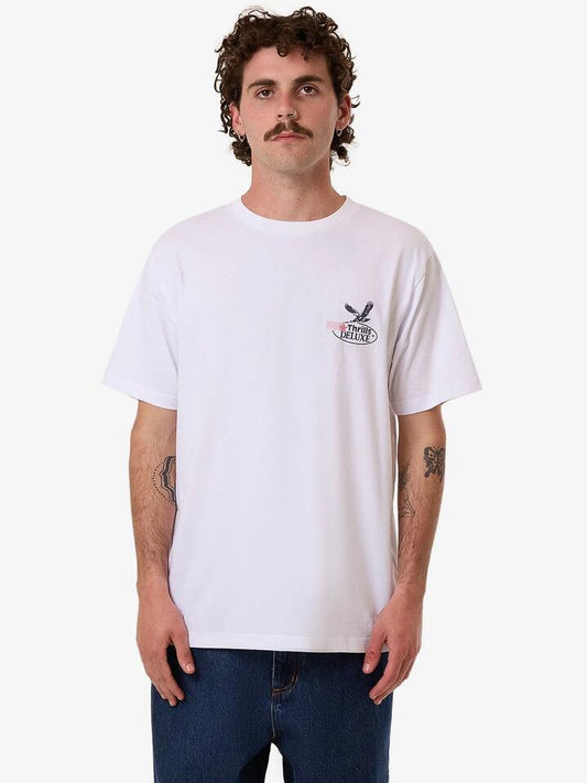 Image of a model wearing Tops. Productname: Thrills Deluxe Merch Fit Tee in White colour by brand - Thrills