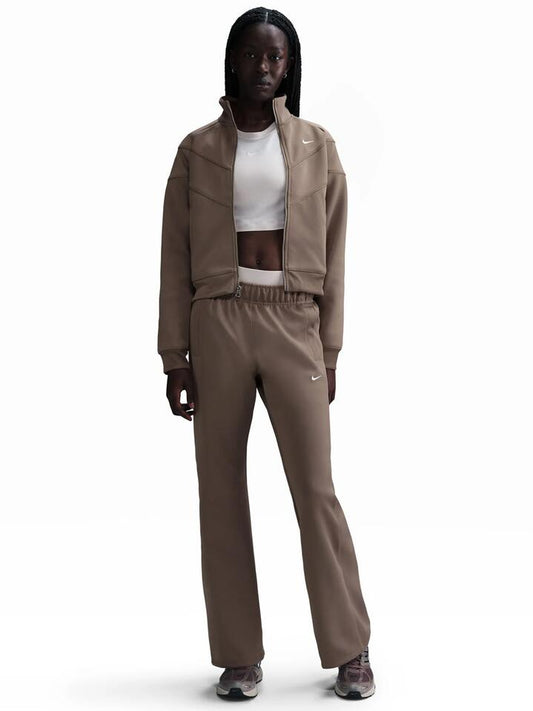 Image of a model wearing Pants. Productname: Nike Sportswear Windrunner Women's Mid-Rise Slim Knit Pants in Mink Brown/White colour by brand - Nike