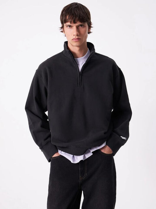 Image of a model wearing Outerwear. Productname: Article One Article Rose 1/4 Zip in Washed Black colour by brand - Article One